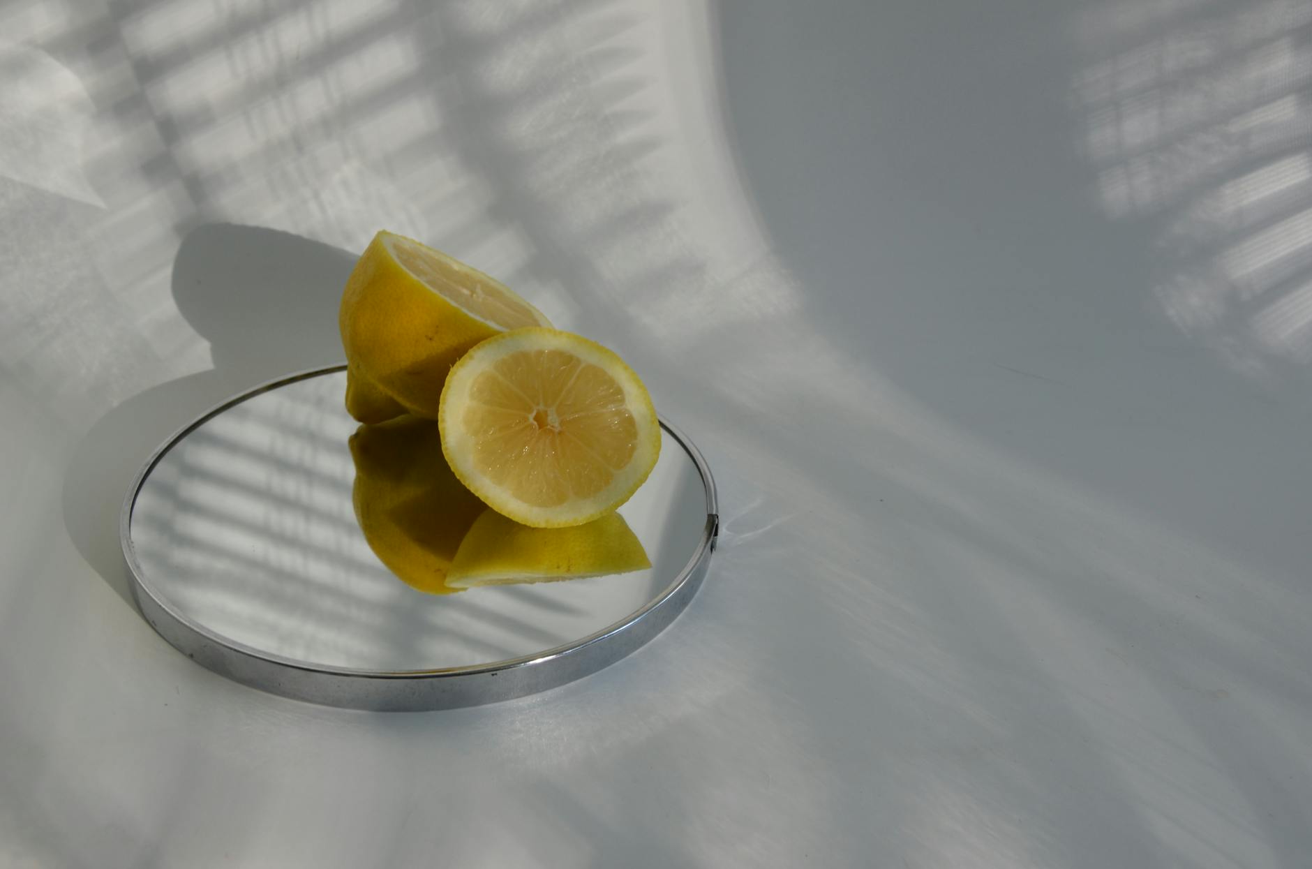 Woman holding lemon clitoral vibrators in a contemplative expression, exploring touch and sensation