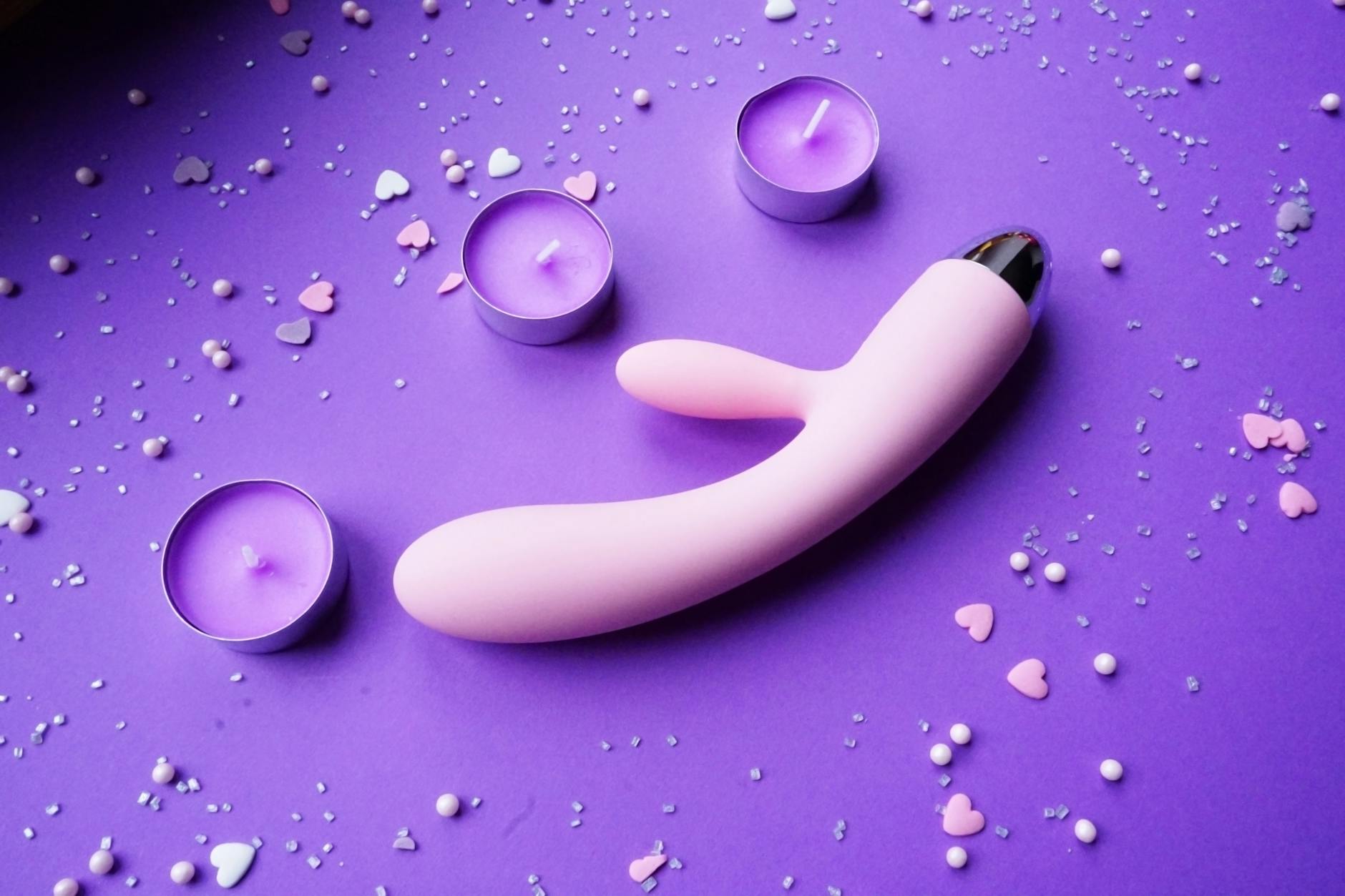A couple standing together holding a vibrator, representing modern intimacy and reconnection